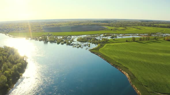 Aerial View Green Forest Woods And Curved River Landscape In Sunny Spring Day alt
