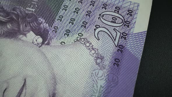 Fifty British Pound paper banknote in close up macro view dolly shot. alt