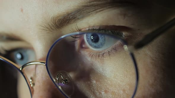 Closeup Eyes of a Teenage Girl with Glasses Looks at the Monitor Plays a Game Reads Studies alt