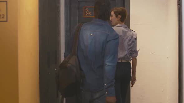 Younf Interracial Couple Entering Room in Hostel or Hotel and Closing Door. Charming Caucasian Woman alt