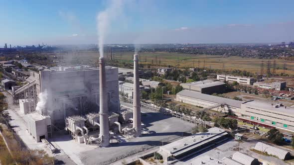 Aerial view. White smoke from the chimneys of an industrial plant