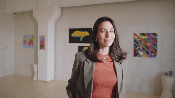 Portrait of Cheerful Woman in Art Gallery alt