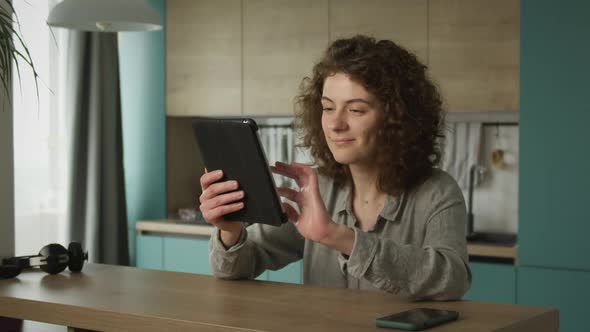 Young 20s Adult Student Opening a Laptop and Begin Working in Her Kitchen alt