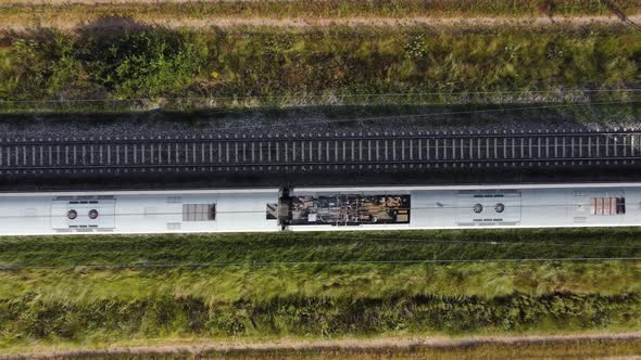 Directly Above Aerial Shot of a Fast Passenger Train in the Countryside alt