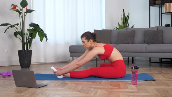 Fit Woman Watch Online Sport Webinar Laptop Doing Warmup Stretching Training alt