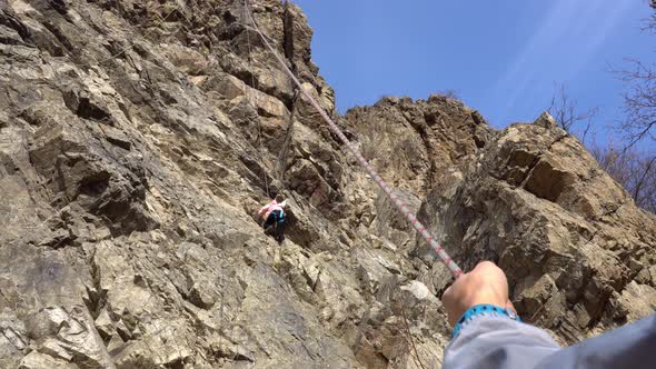 The Girl Goes Up the Cliff As a Safety Net for Guy alt