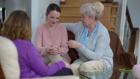 Young Troubled Woman Crying As Wise Senior Grandmother and Adult Mother Calming Down Sad Beautiful alt
