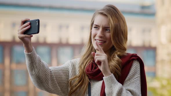 Cheerful Girl Making Video Call By Phone. Young Woman Showing Thumb Up at Camera alt