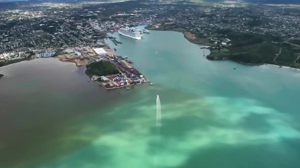 Drone shot of the city on island with boat and liner in harbor in Saint John's, Antigua and Barbuda alt
