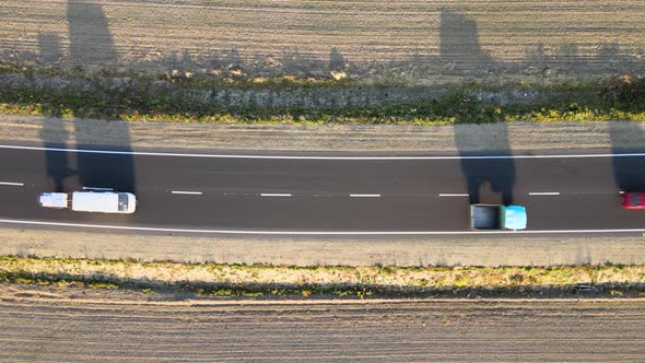 Aerial View of Intercity Road with Fast Driving Cars at Sunset alt