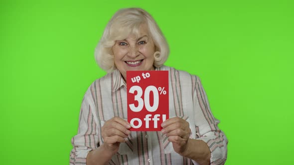 Senior Grandmother Showing Up To 30 Percent Off Inscription Signs, Rejoicing Discounts. Black Friday alt
