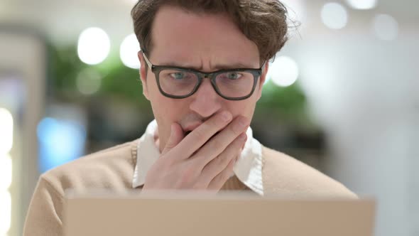 Close Up of Young Male Designer Reacting to Loss on Laptop alt