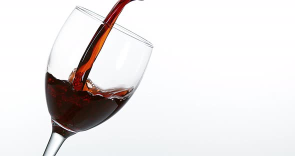 900055 Red Wine being poured into Glass, against White Background, Slow motion 4K alt