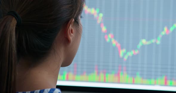 Woman check the stock market data with computer alt