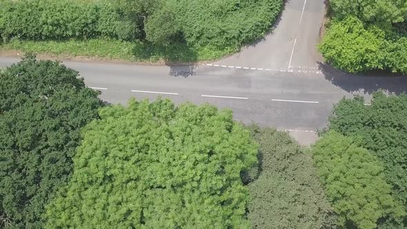 Aerial top shot pan of rural road on a summer day in Devon, UK, STATIC CROP alt
