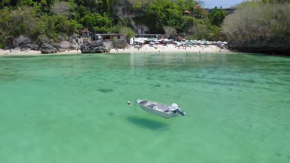 Aerial Drone Flight Near Small Anchored Boat Near Labuan Saint Beach Bali Indonesia alt