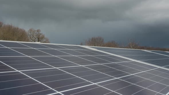 Storm clouds time lapse over solar farm panels, renewable sustainable energy alt