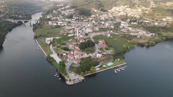 Entre-Os-Rios waterfront town over Douro river and Ponte De Pedra bridge in background. Aerial view