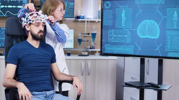 Male Patient in Modern Technology on His Head for Reading Brain Activity alt