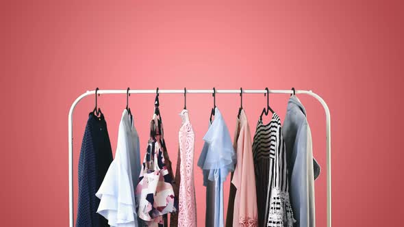 Women's clothing on a white clothes hanger on different pastel colors background