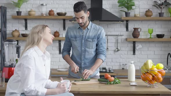 Handsome Middle Eastern Man Cutting Cucumber for Healthful Salad and Arguing with Beautiful alt