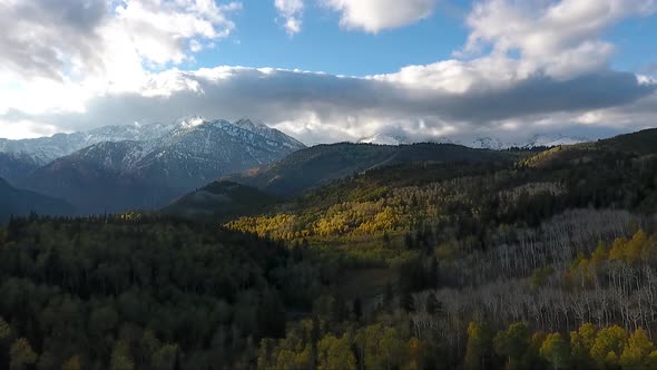 Fall colors, Golden Quaking Aspens, rugged snow capped mountains and fluffy white clouds are part of alt