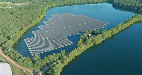 Aerial View of Platform System of Floating Solar Panels in Blue Pond the Sunlight alt