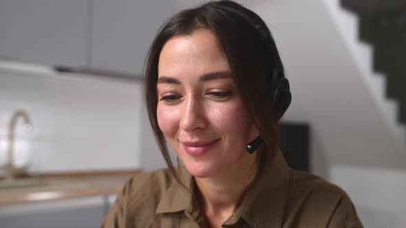 Young Female Employee Wearing Wireless Headset Talking Online