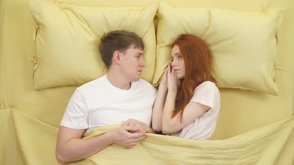 Top View of Beautiful Young Couple Sleeping Together in Bed at Home Yellow Bed