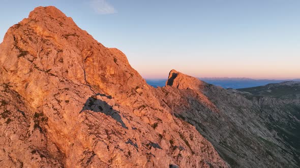 Dolomites mountains peaks with a hiking path on a summer sunrise alt
