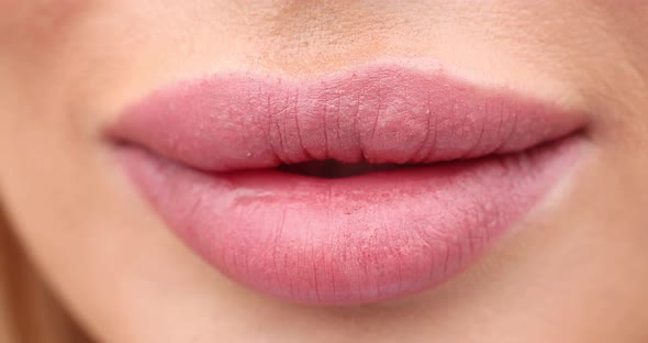 Extreme Close-up Female Mouth with Pink Lipstick Smiling Showing White Healthy Beautiful Teeth