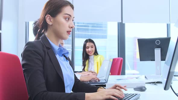 Asian employee officer attractive positive smile woman working on desktop alt
