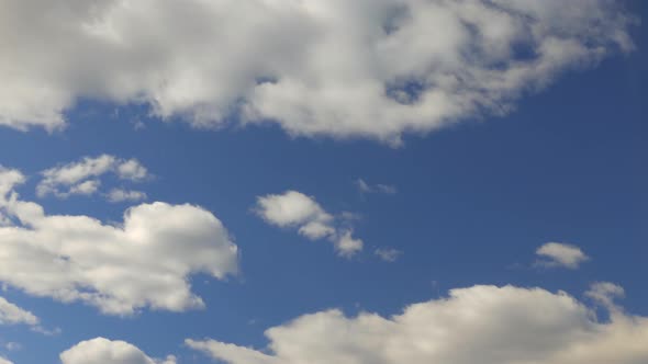 White Clouds Move Across a Beautiful Blue Sky. Nice Sunny Weather.