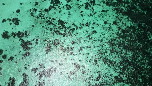 Aerial top down of tropical turquoise water in Koh Lipe Thailand revealing small island in the Andam alt