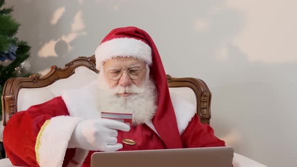 Santa Claus copying his credit card numbers when buying gifts on the internet.