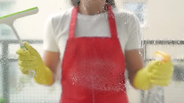 Cleaning Service Worker or Housewife Washes the Windows Using Detergent and Scraper for Cleaning alt
