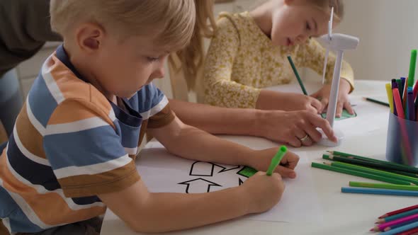 Tracking video of children coloring a recycle symbol. Shot with RED helium camera in 8K alt