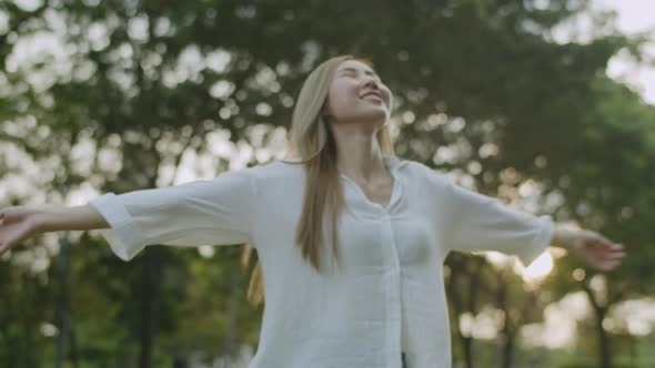 A beautiful Asian woman closed her eyes enjoying the breeze.