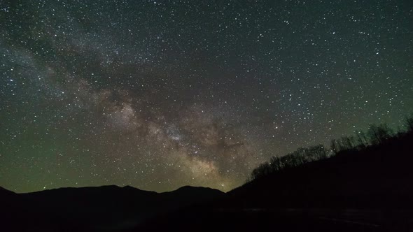 Milky way moving over silhouette of mountains at Osum River, Albania alt