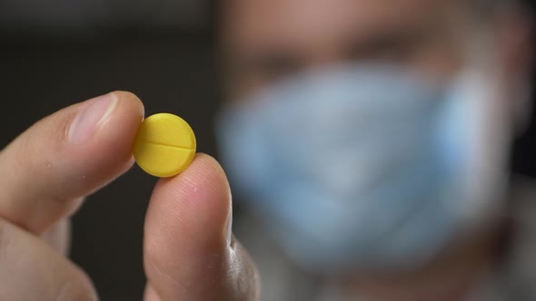 Doctor Offering Yellow Pill