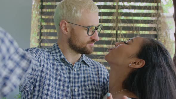 A Young International Interracial Couple in Love Making Selfie Photo on a Sunny Day at Home Garden alt