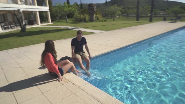 Couple Relaxing on Pool of Huge Country Estate