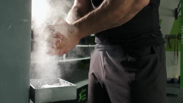 Athlete Is Preparing, Hands Claps After Magnesia in Fitness Center. Super Slow Motion alt