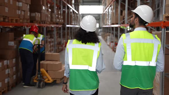 Logistics Specialists Walking Through Storehouse alt