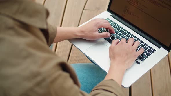 Man Using Laptop Outdoor Top View alt