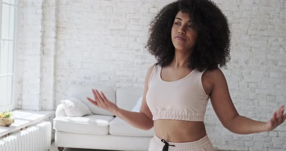 A Satisfied Mixedrace Woman Enjoys Rhythmic Movement alt