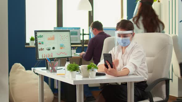 Woman with Visor Using Phone with Wireless Headphone for Videocall alt