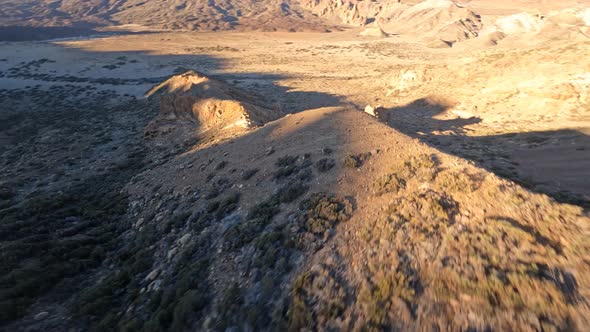 FPV Drone Flying Close Over a Desert Like Landscape with a Mountain Volcano in the Background alt