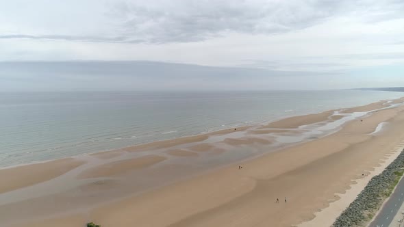 Spectacular aerial drone view of Omaha Beach landing area in Colleville sur Mer, Normandy, France alt
