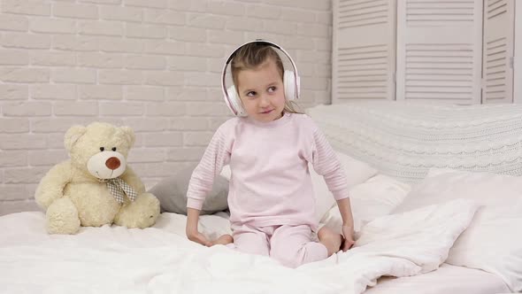 Little Child Baby Girl Listening To the Music with Headphones